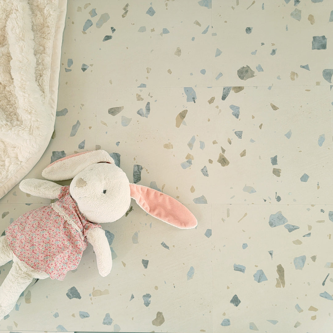 Allure terrazzo vinyl flooring with blanket and stuffed bunny