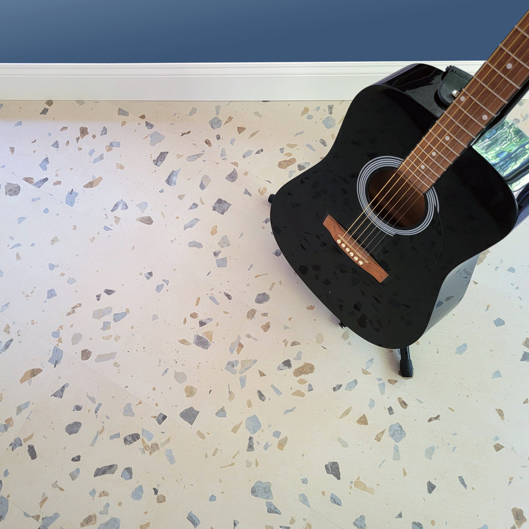 Allure terrazzo vinyl floor in blue room with black guitar