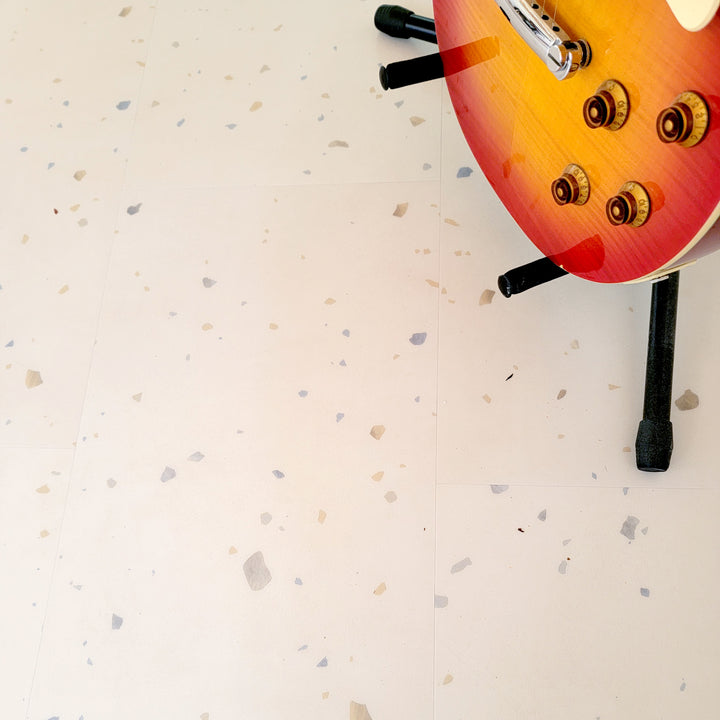 Perfect parfait terrazzo vinyl tiles with a sunburst electric guitar in stand