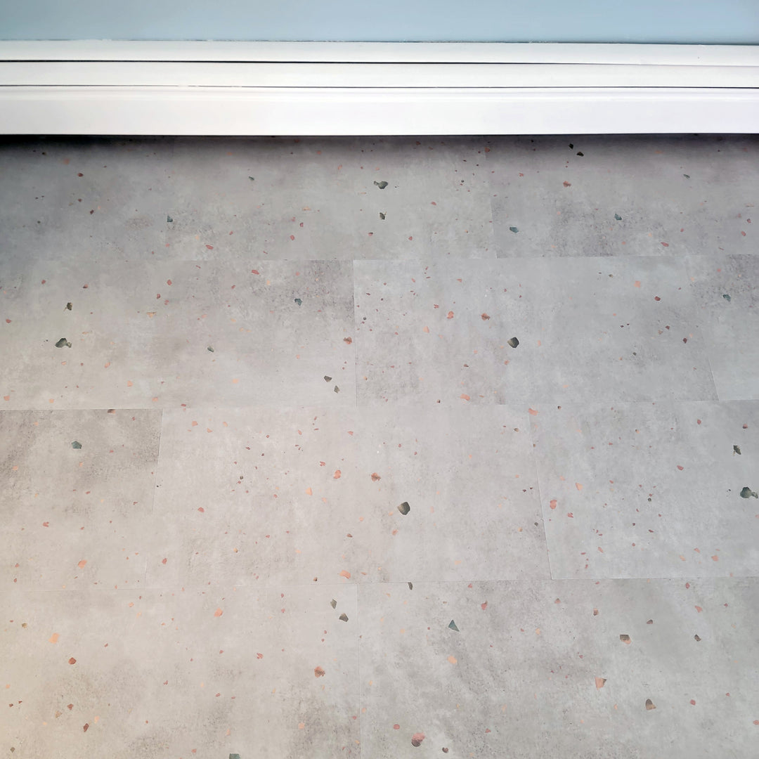 terrazzo vinyl floors with white baseboard radiator