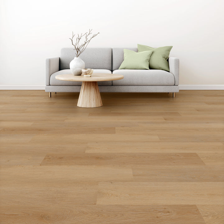 Alure honey butter oak plank flooring in a room with sofa and coffee table with a vase on top.