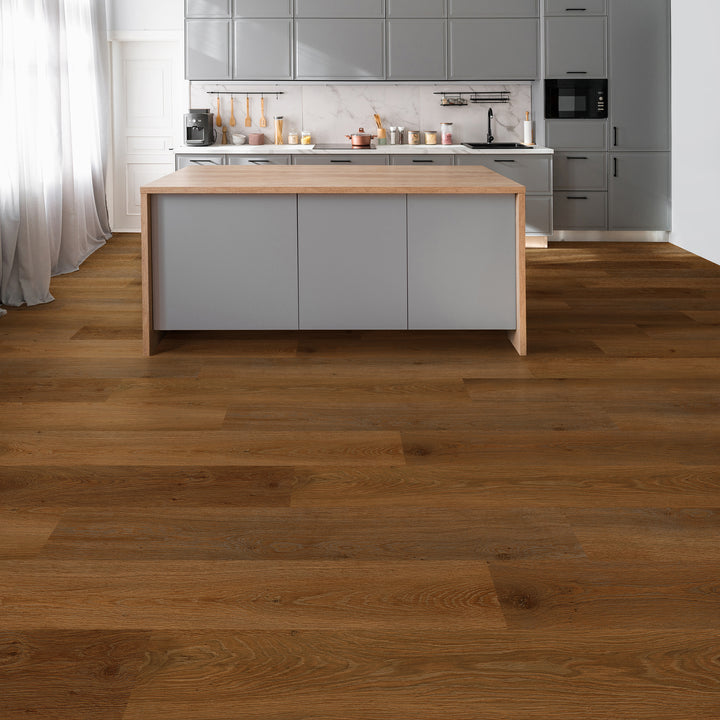 Allure Caramel Cookie plank flooring in a kitchen with a table island and kitchen fixtures.