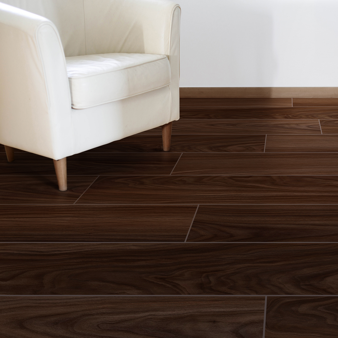 Allure velvet mocha walnut plank flooring in a room with a white wall and white armchair