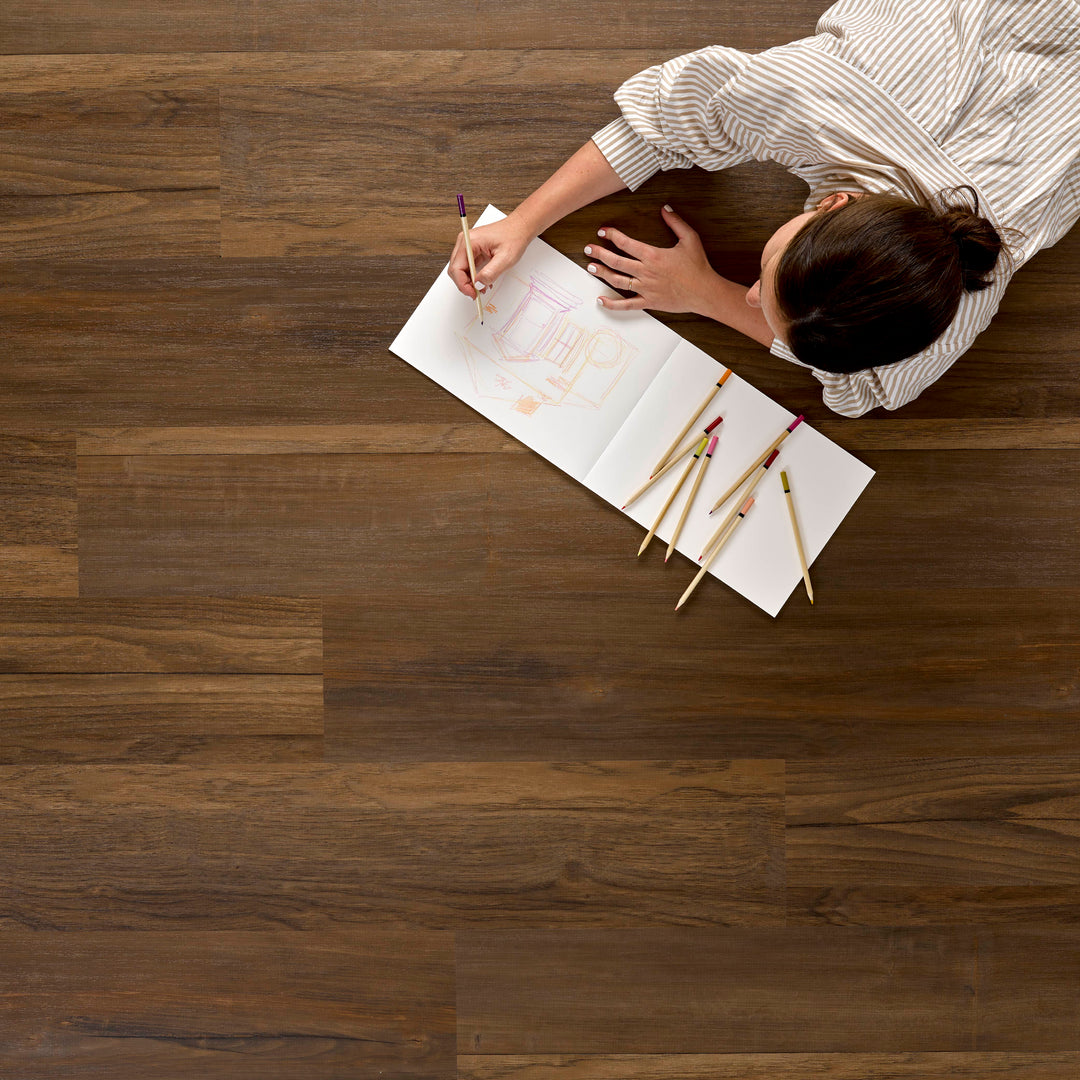 Allure SRP TPU Flooring in Mixed Timber Driftwood installed floor view from above with person drawing