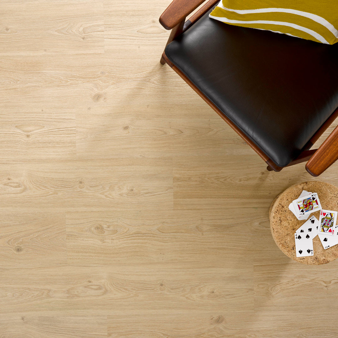 Allure SRP TPU Flooring in Natural Oak Nutmeg installed floor view from above with a chair and end table