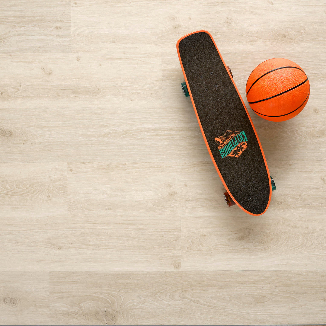 Allure SRP TPU Flooring in Soft Oak Sand installed floor view from above with skateboard and basketball