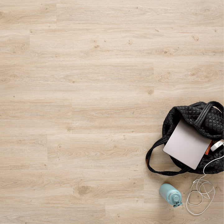 Allure SRP TPU Flooring in Soft Oak Clay installed floor view from above with black tote bag and bottle