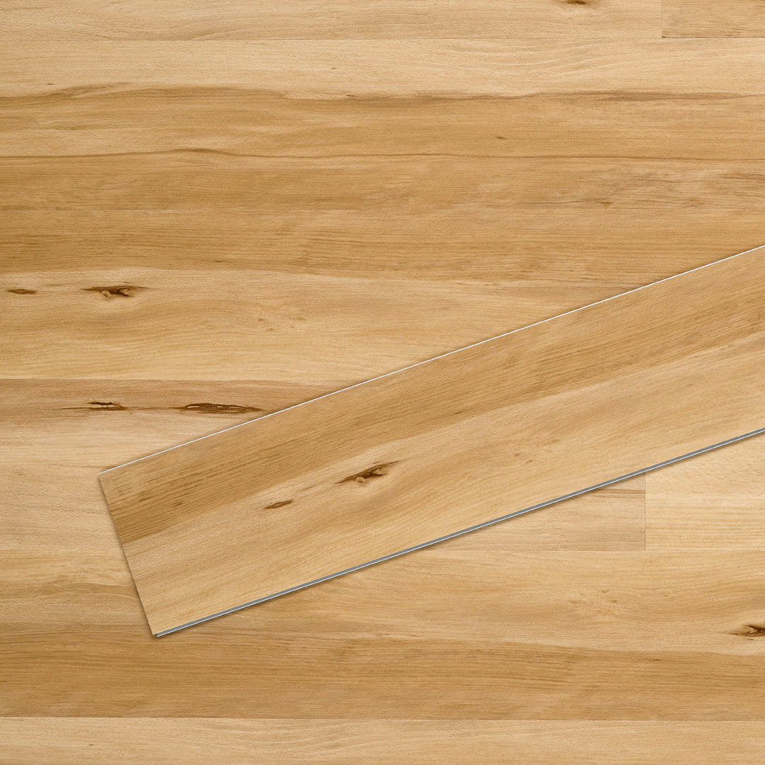 Allure SRP TPU Flooring in Modern Beech Natural installed floor view from above with single plank laying on top