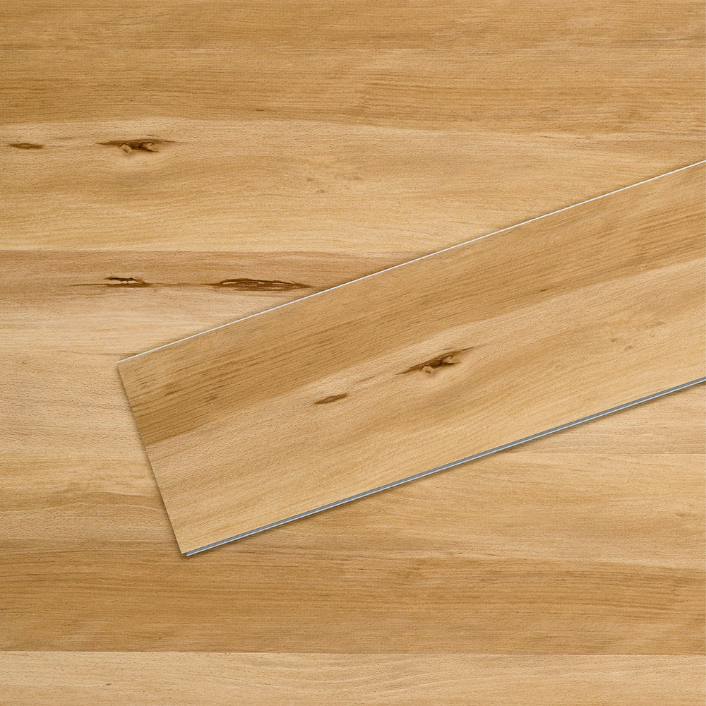 Allure SRP TPU Flooring in Modern Beech Natural installed floor view from above with close up of single plank laying on top showing grooves and edges