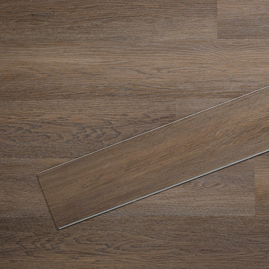 Allure SRP TPU Flooring in Pure Oak Midnight installed floor view from above with single plank laying on top